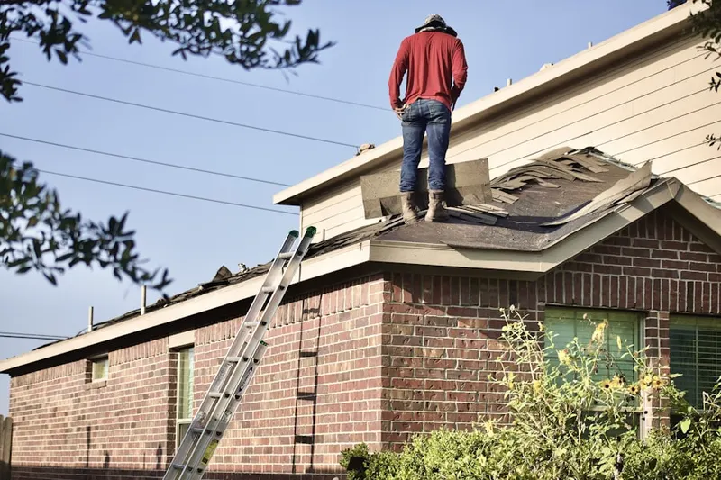 Professional roofer working on a residential roof in Peace Church